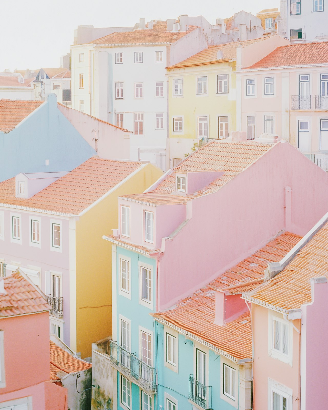 Pastel-coloured buildings with terracotta roofs in Lisbon